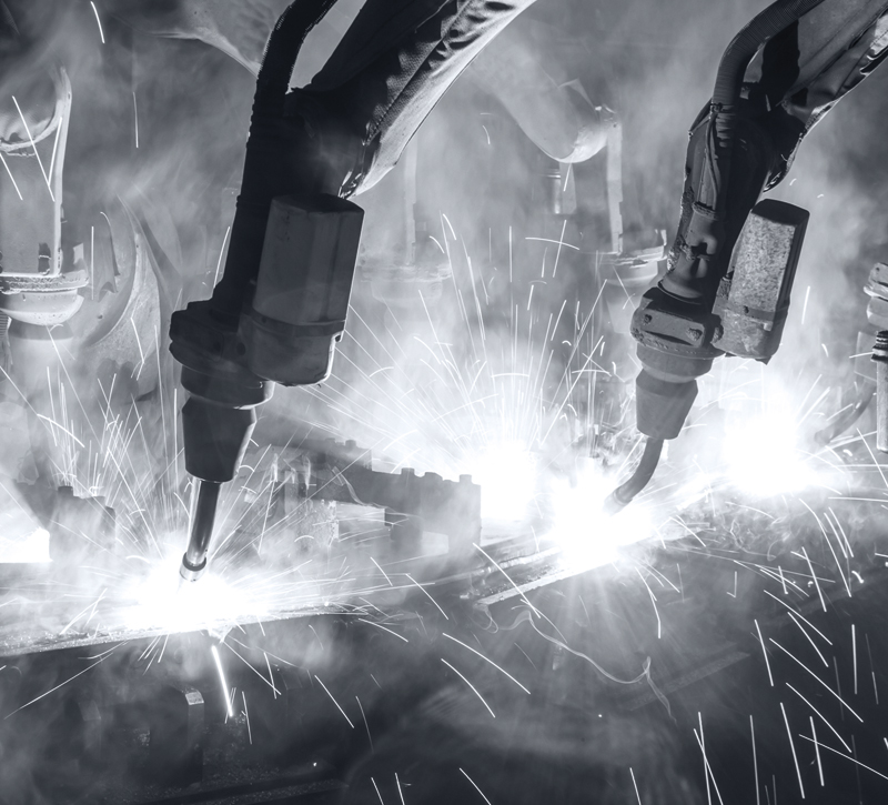 Symbolic photo of welding robots performing their work